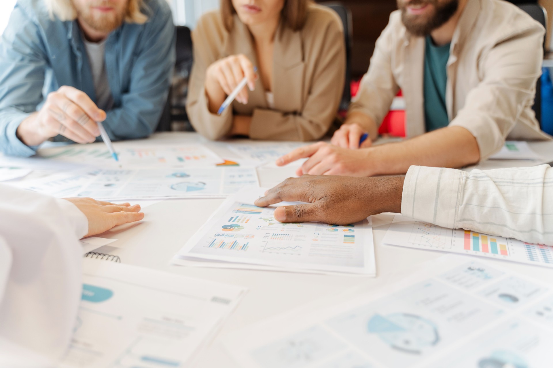 Diverse group of professionals analyzing financial data in a business meeting